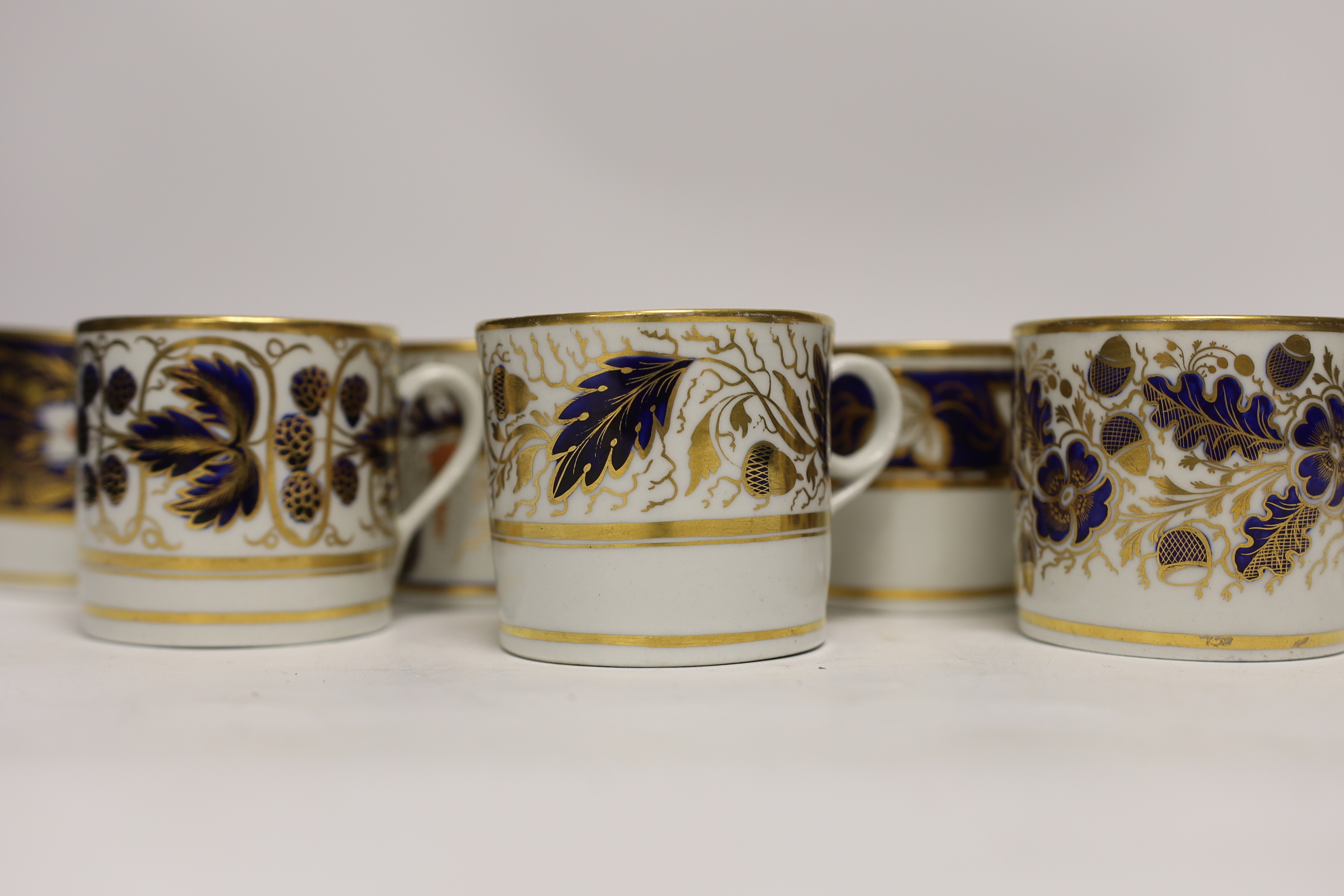 Twelve 1800-1820 English porcelain, mostly blue and gilt decorated coffee cans